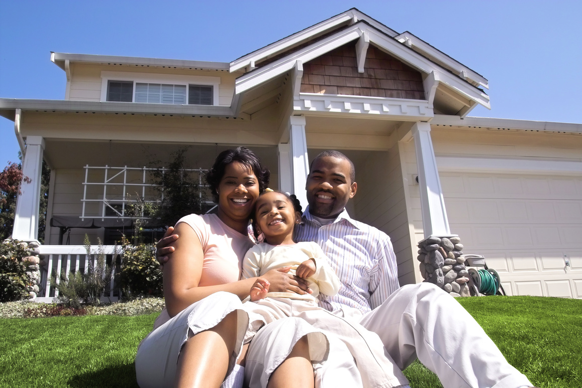 Family In Front of House